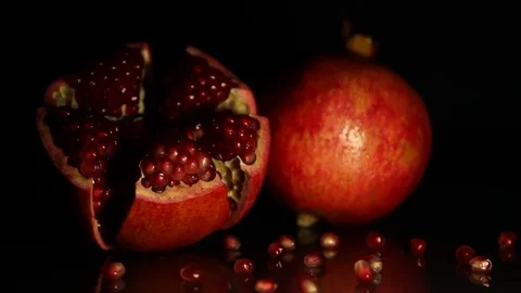 Two bright large grenades rotate against a black background. HD. Close-up Stock Footage 89963015