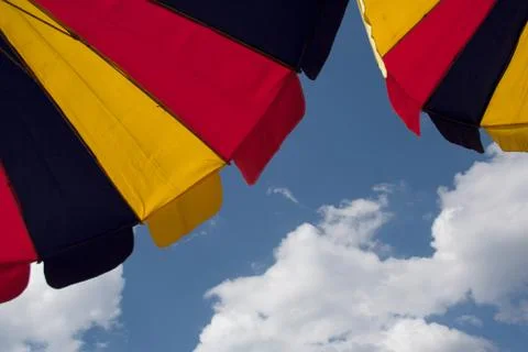 Two bright multicolored umbrellas Stock Photos
