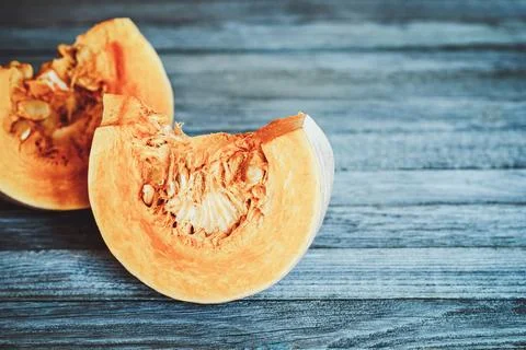 Two bright orange pumpkin slices on gray background Stock Photos