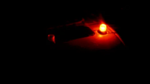 Two bright orange warning lights blinking on a dark vehicle roof at night Stock Footage 346795490