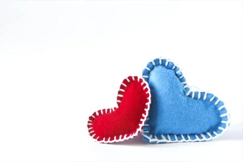 Two bright red and blue hearts in close-up on a light background. Stock Photos