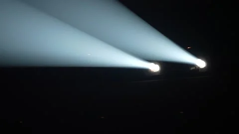 Two bright white stage spotlights emitting strong beams in dark Stock Footage 346357888