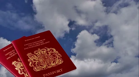Two British passports with clouds Stock Footage 64843452