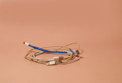 Two broken bare and rewound USB wires with duct tape Stock Photos