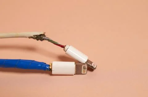 Two broken bare and rewound USB wires with duct tape Stock Photos