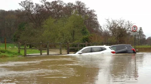 Two Broken Down Cars Submerged In a flooded Ford / River. UK Stock Footage 144388308