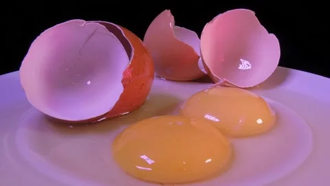 Two broken, raw eggs Stock Footage 154255448