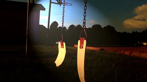 Two broken swings swaying back and forth Stock Footage 39932366