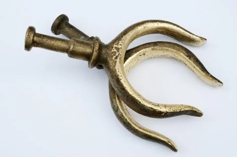 Two bronze oarlocks on a light background Stock Photos