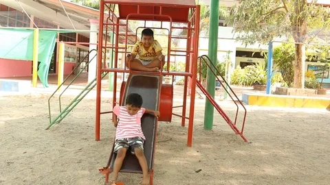 Two brother playing at playground Stock Footage 73714961