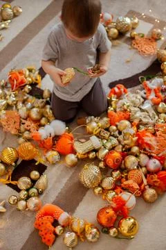 Two brothers are assembling an artificial Christmas tree from branches in their Stock Photos