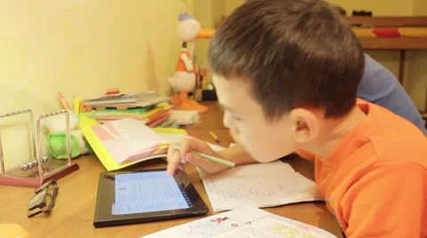Two brothers doing homework and using tablet computer Vídeo Stock 47345050