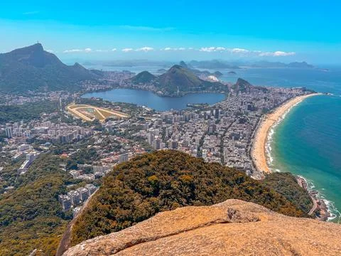 Two brothers hike Rio de Janeiro - man enjoying the view over Copacabana and Stock Photos