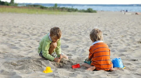 Two brothers playing on the beach Stock Footage 25672732