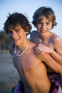 Two brothers playing on beach Stock Photos
