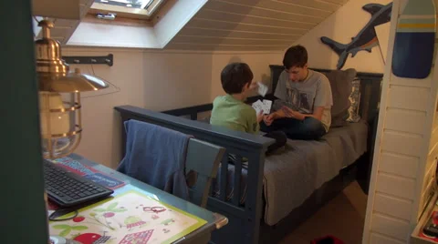 Two brothers playing cards at home, boys enjoying game, having fun Stock Footage 33797112