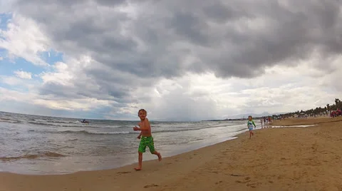 Two brothers running on the beach Stock Footage 25672641