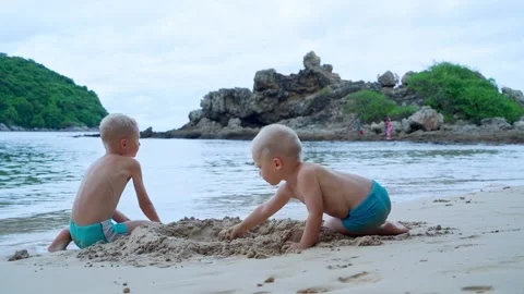 Two brothers spend time together at the seaside during their summer holidays. Stock Footage 226491740