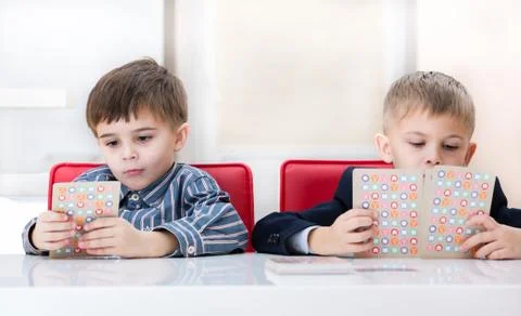 Two brothers at the table Stock Photos