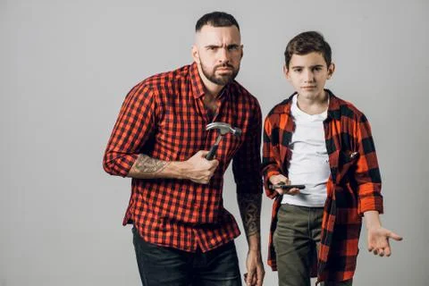 Two brothers with tools don't know how to repair fence Stock Photos