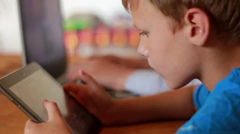 Two Brothers Using Laptop And Ipod Stock Footage 40746062