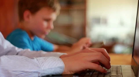 Two Brothers Using Laptop And Ipod Stock Footage 40746087