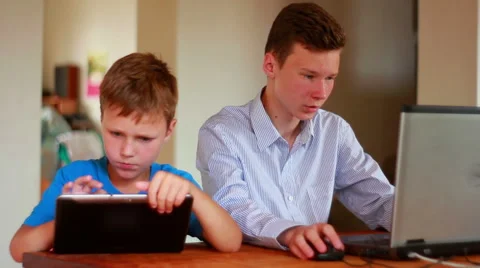 Two Brothers Using Laptop And Ipod Stock Footage 40746158