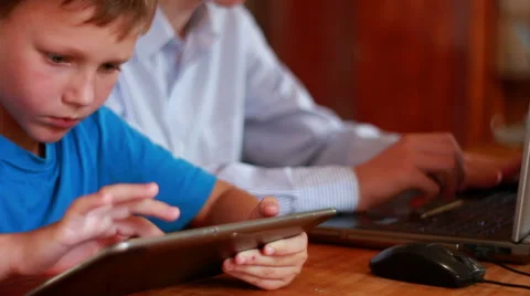 Two Brothers Using Laptop And Ipod Stock Footage 40746185