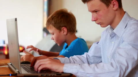 Two Brothers Using Laptop And Ipod Stock Footage 40746191