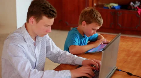 Two Brothers Using Laptop And Ipod Stock Footage 40746215