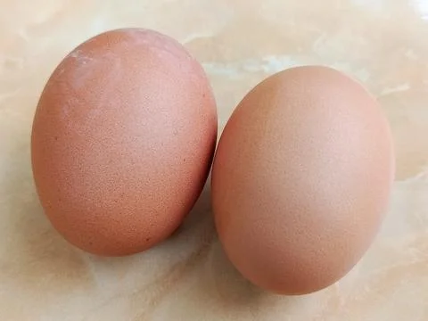Two Brown Chicken Eggs on Neutral Surface as Simple Fresh Food Concept Stock Photos