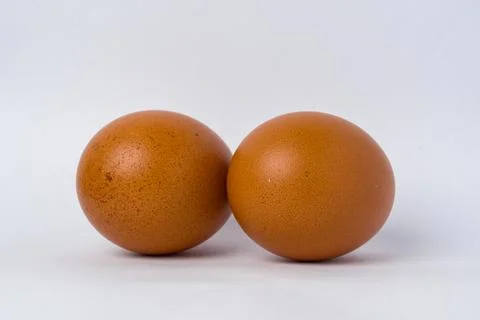 Two brown eggs sit side by side Stock Photos