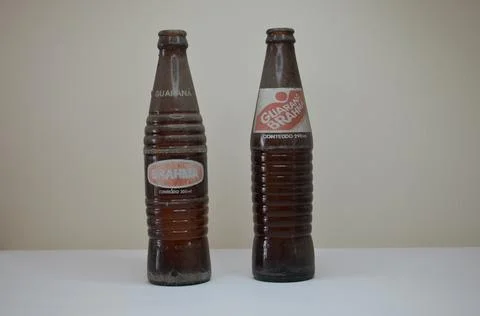 Two brown glass empty bottles of exticted soda brands. Guarana brahma. brazi Stock Photos