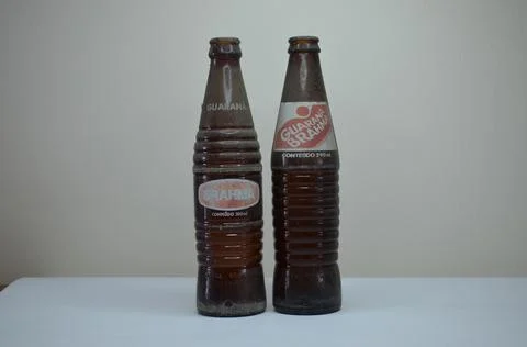 Two brown glass empty bottles of exticted soda brands. Guarana brahma togeth Stock Photos