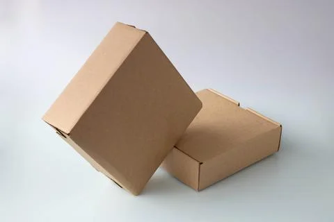 Two brown narrow cardboard boxes on a white background Foto stock