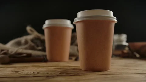 Two brown one-off paper cups for hot beverages with copy space.Take away 2 for 1 Stock Footage 136814291