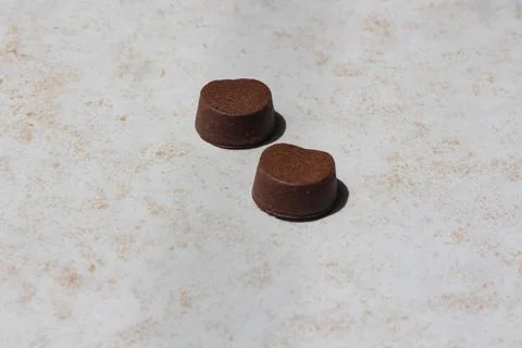 Two Brown tablets to protect from fleas for cats and dogs Stock Photos