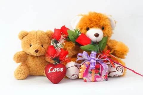 Two brown teddy bear with a red rose and a gift box on a white background. Stock-Fotos