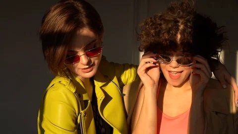 Two brunettes in sunglasses pose for the camera.  스톡 동영상 102628723