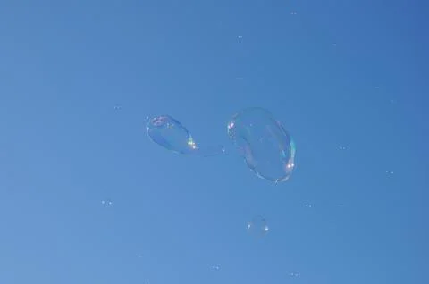 Two bubbles from the bubble blower floating on the sky Stock Photos