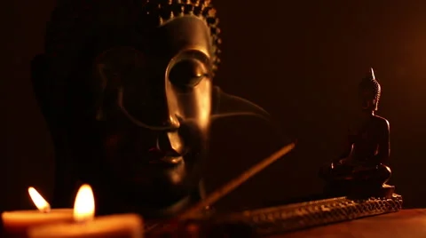 Two Buddha statue with candles and smoke of incense Stock Footage 45955343