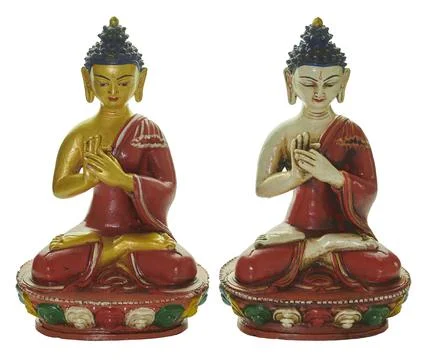 Two buddha statues meditating symbolizing peace and spirituality Stock Photos