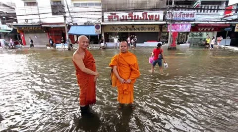 Two Buddhist monks in flood Stock Footage 10424085