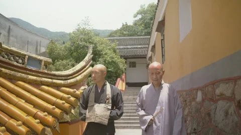 Two Buddhist monks walking down stairs in a Chinese temple Stock Footage 340563276