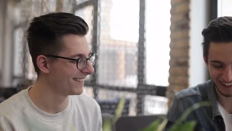 Two buddies sitting in the cafe and chatting with each other Stock Footage 74855475