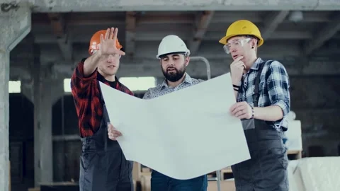 Two builders and engineer architect study a work plan. Building industry concept Stock Footage 131692442
