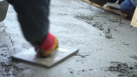 Two builders level the concrete surface Video stock 287988860