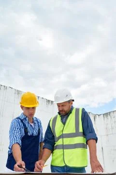 Two Builders Looking at Floor Plans on Site 写真素材