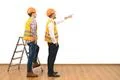 The two builders near ladder gesture on the white wall background Photo