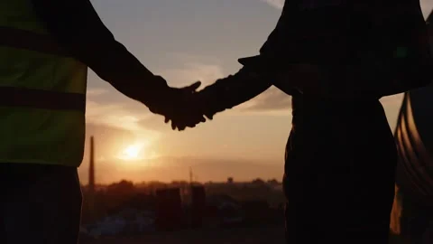 Two builders stand and shake their hands Video stock 157872466